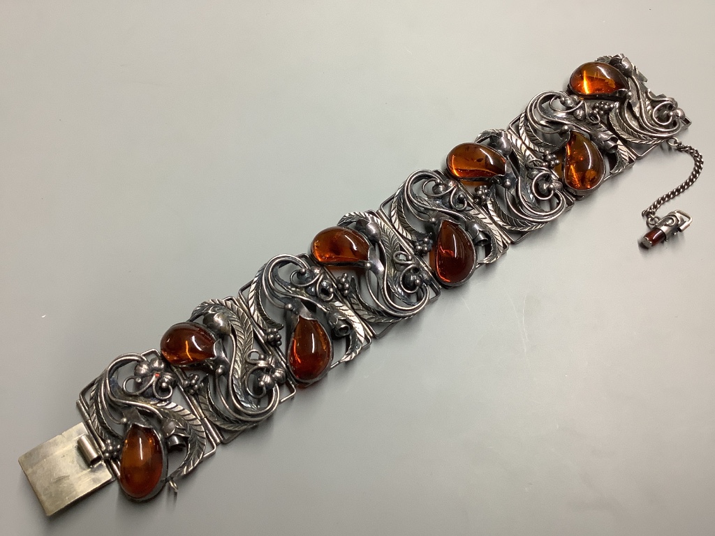 A 925 white metal and amber bracelet of foliate design, gross 56 grams.